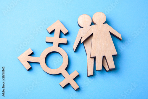 Symbol of transgender and silhouettes of man and woman of wood on blue