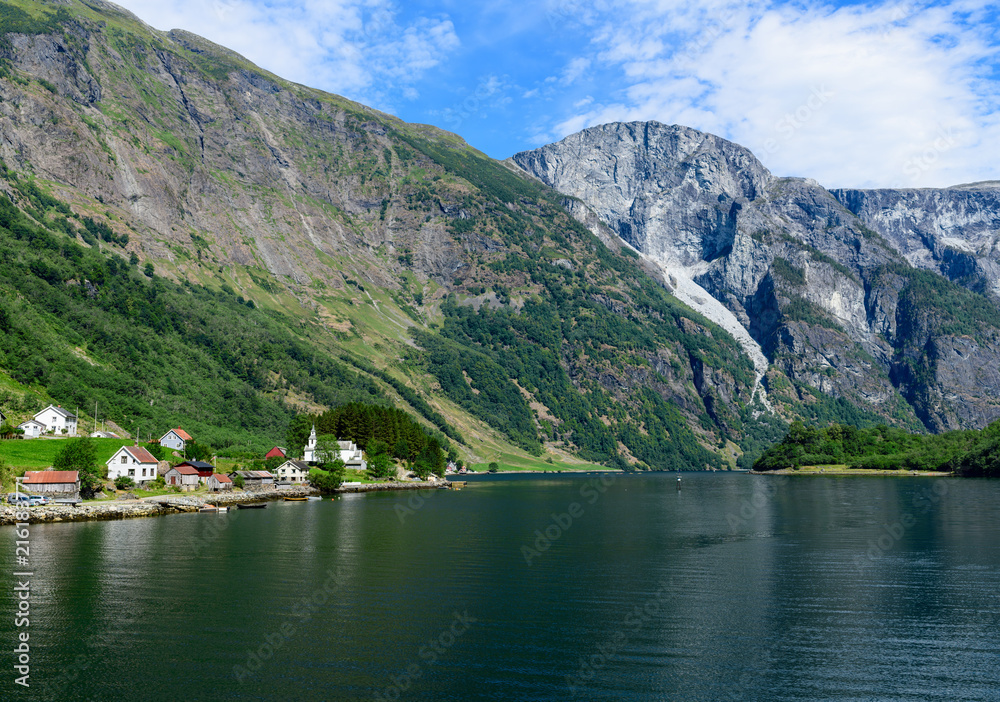Landscape with the village on the banks of Naeroyfjord. Naeroyfjord offshoot of Sognefjord is the narrowest fjord in Europe.  Aurland, Sogn og Fjordane, Norway, Europe.