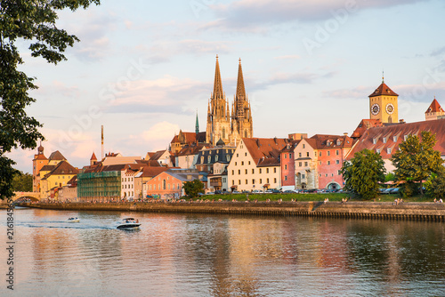 Regensburg city view, Germany. People enjoy beauty on Danube river shore, Regensburg Cathedral and architecture on background
