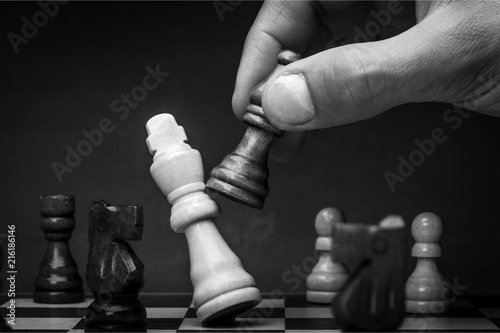 Businessman Hand Holding a Chess Piece