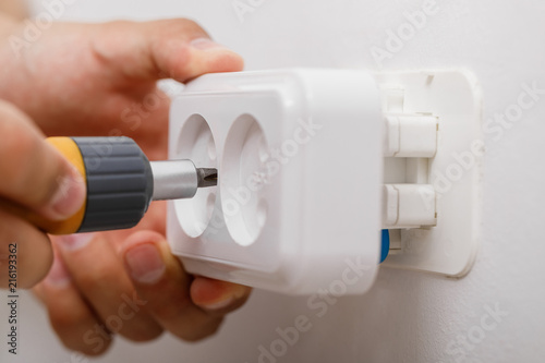 electrician installing electrical socket