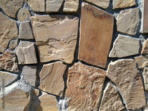 texture natural stone. rock. brown. sunny day.
