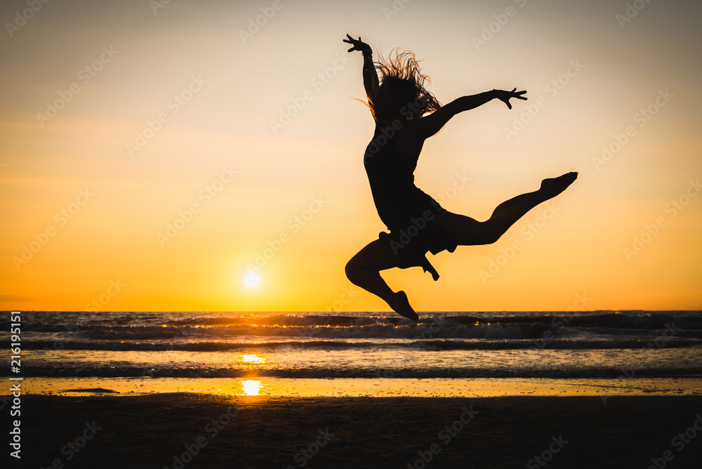 Silhouette of a happy beautiful dancer girl at sunset Silhouette of a happy beautiful dancer girl at sunset