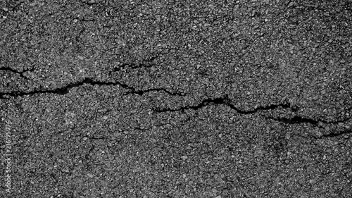 crack and texture of asphalt road - top view background.