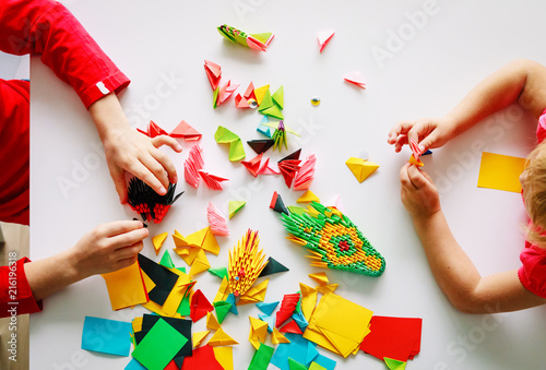 kids making origami crafts with paper