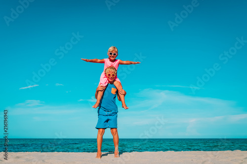 happy little boy and girl play at sky