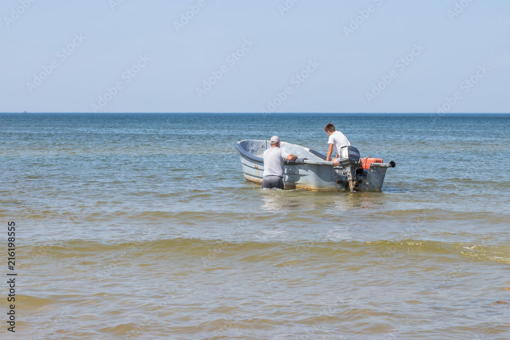 fishermen in a boat sail into the sea fishermen in a boat sail into the sea