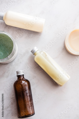 Spa cosmetics on white marble background from above. Beauty blogging concept
