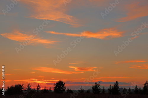 Beautiful orange bright sunset with blue sky and wonderful clouds