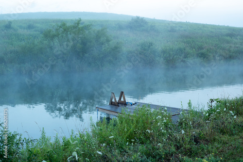 Foggy pond with dock