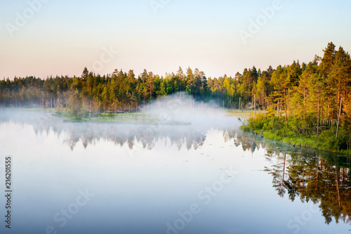 Morning fog at the forest lake in Karelia