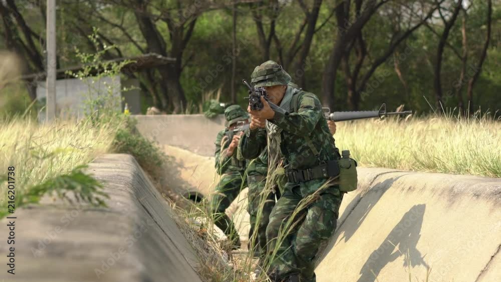 Soldier armed with a reconnaissance patrol in the woods. Concept of war, army and military. Soldier armed with a reconnaissance patrol in the woods. Concept of war, army and military.