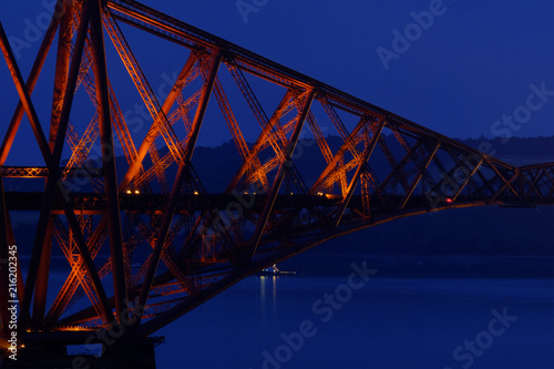 Close up photo of a historic iron bridge at night