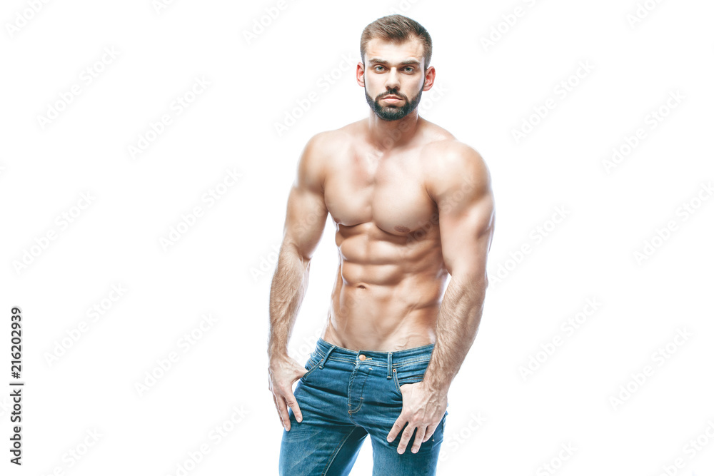 Fototapeta premium bodybuilder posing. Beautiful sporty guy male power. Fitness muscled in blue jeans. on isolated white background.