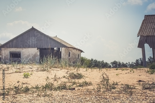 Ruined house and barn on an abandoned farm, vintage