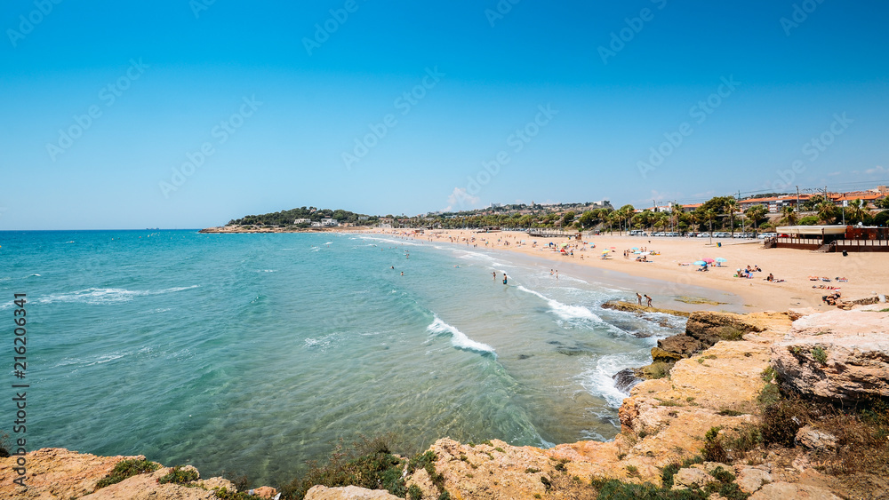 Vacationers in Arrabassada Beach, one of the famous golden sand beaches in the Spanish Costa Daurada
