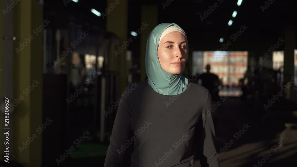 Young muslim sports girl in hijab came to the gym for training.Slow mo Young muslim sports girl in hijab came to the gym for training.Slow mo