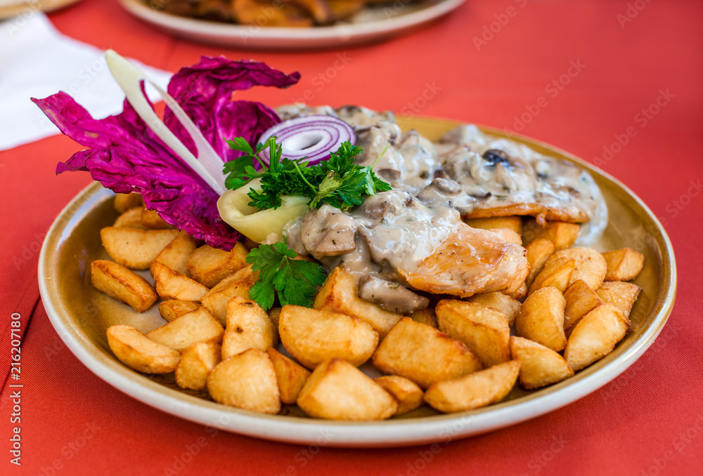 Roast chicken steak in white mushroom sauce with fried potato wedges Roast chicken steak in white mushroom sauce with fried potato wedges