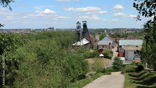 View of Bois du Cazier Coal Mine - Marcinelle, Belgium and the town of Charleroi behind photo