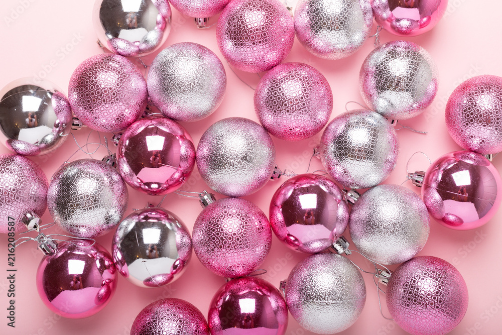 Pink and silver christmas balls on a paper background. Top view, flat lay, copy space Pink and silver christmas balls on a paper background. Top view, flat lay, copy space