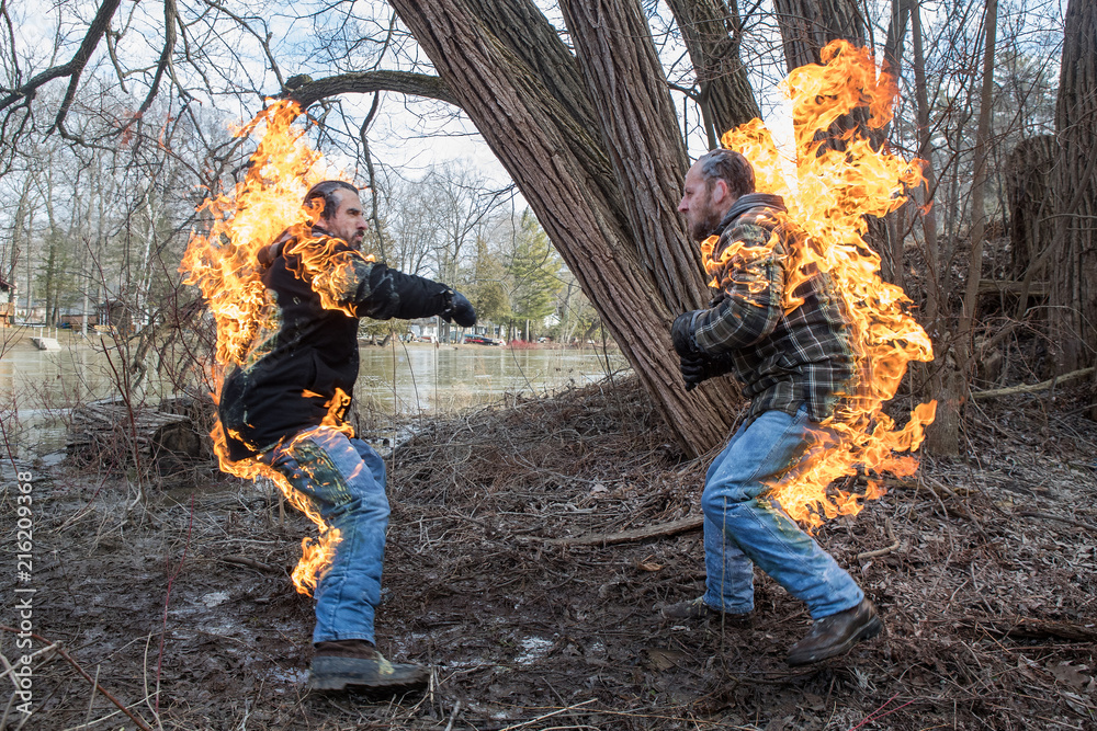 Stunt Men light themselves on fire and fight in their backyard