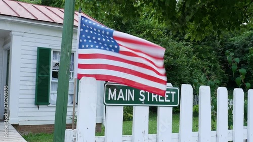 American Flag with Main Street sign and picket fence photo