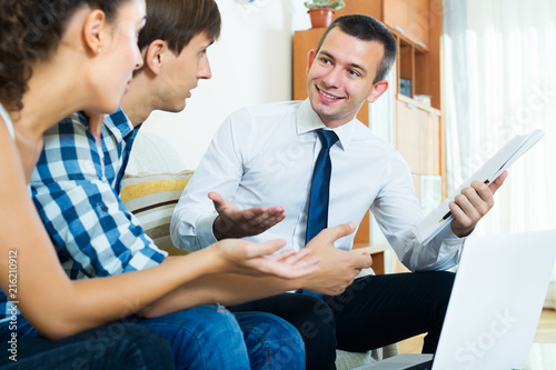 Spouses and salesman with documents