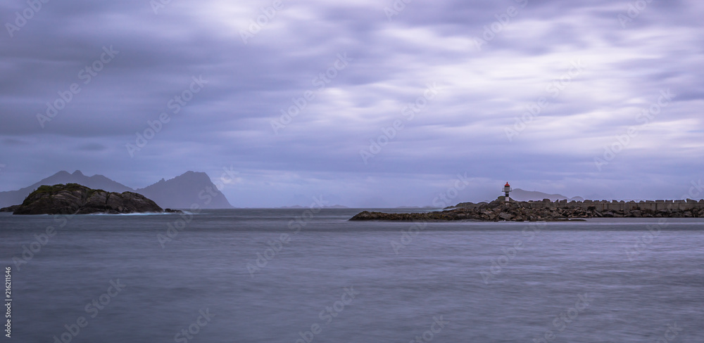 Henningsvaer- June 15, 2018: Distant lighthouse of a small village in the Lofoten Islands, Norway