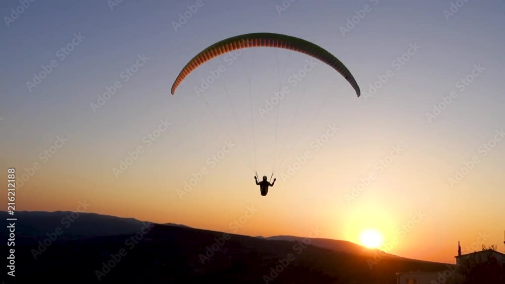 Close-up: paraglider is flying in the direction of the Sun
