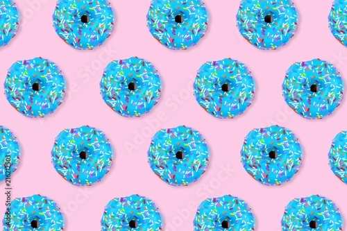 Colorful food pattern. Soft blue iced donuts on a pastel pink background. Top view.