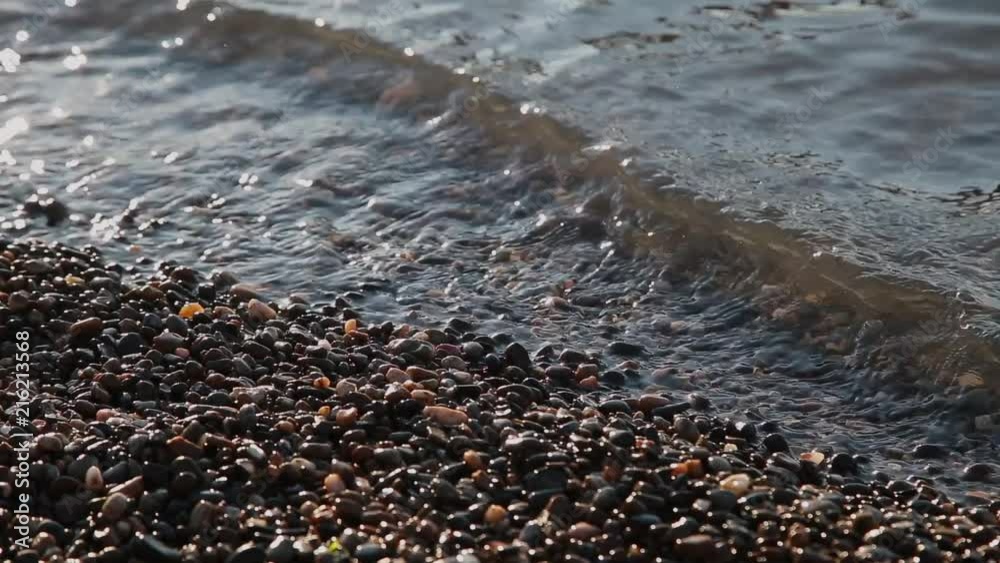 Sea waves swim ashore on a sunny day. Sea waves swim ashore on a sunny day.