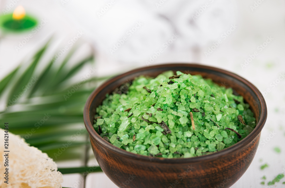 Spa. Green herbal spirulina salt in ceramic bowl, spa towels, candles and bamboo Spa. Green herbal spirulina salt in ceramic bowl, spa towels, candles and bamboo