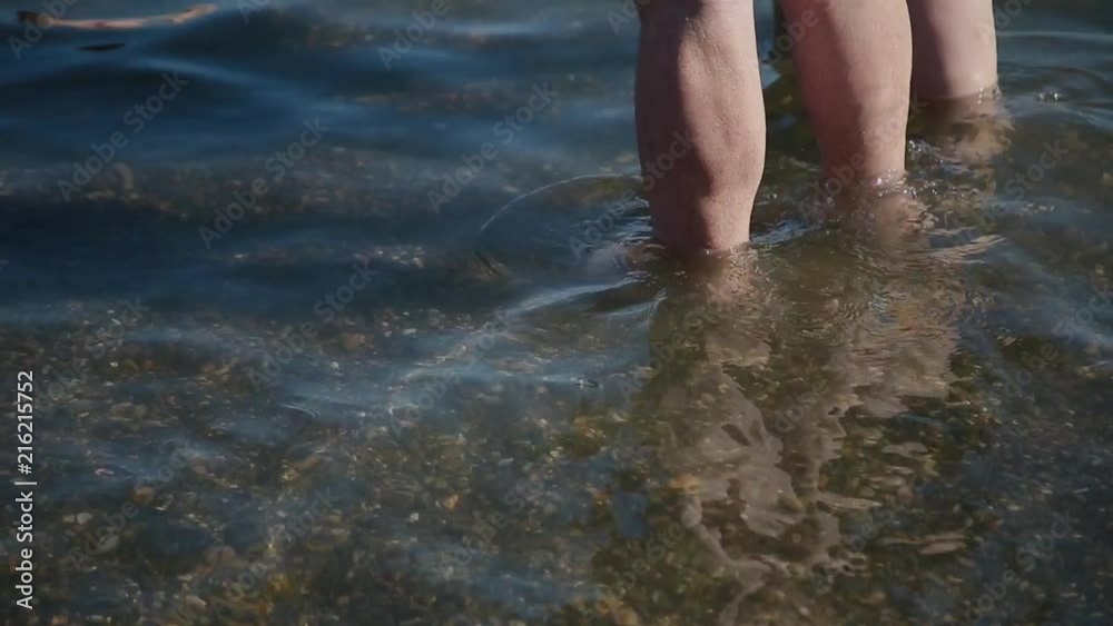 Legs in sea water, with an influx of waves. Legs in sea water, with an influx of waves.