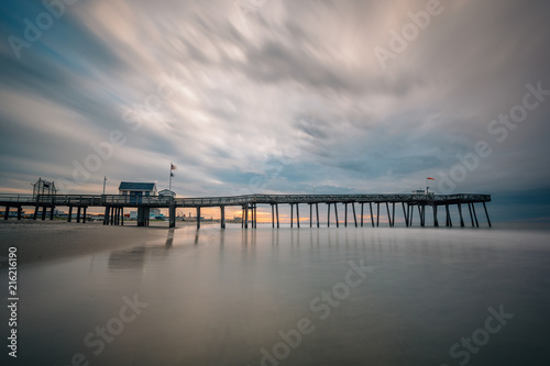 A pier at sunrise in Ocean City, New Jersey. © jonbilous