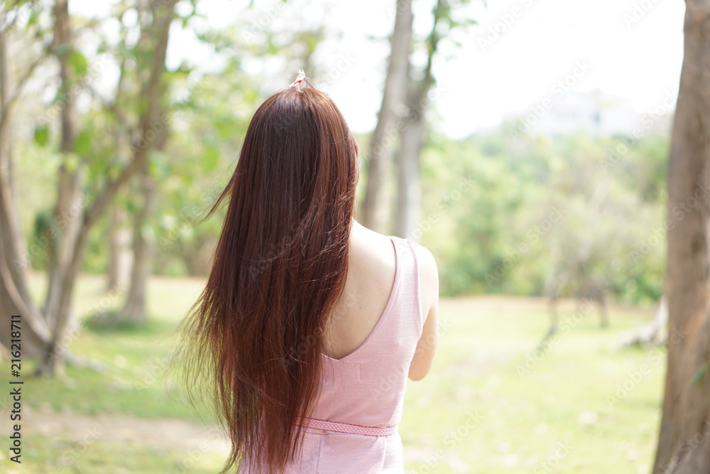 Young woman with long brown hair. Relaxing with deep clear air and blur background natural and tree. Young woman with long brown hair. Relaxing with deep clear air and blur background natural and tree.