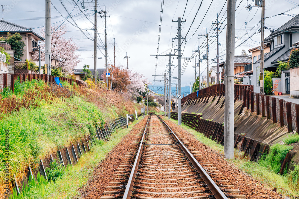 Railway and kyoto old town with cherry blossoms in Kyoto, Japan Railway and kyoto old town with cherry blossoms in Kyoto, Japan
