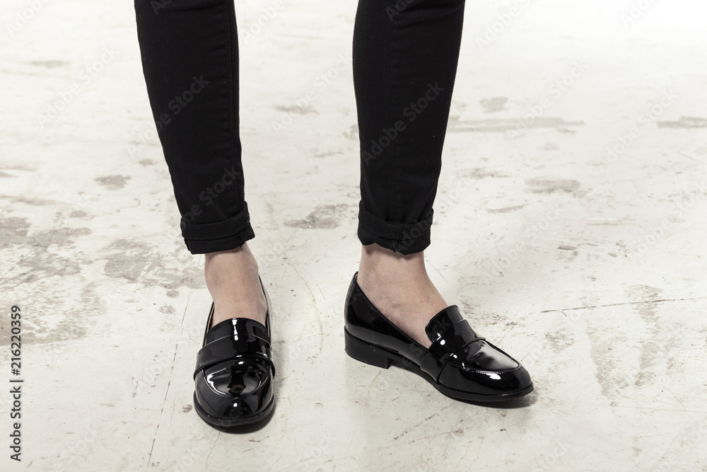 woman wearing black enamel shoes isolated white. woman wearing black enamel shoes isolated white.
