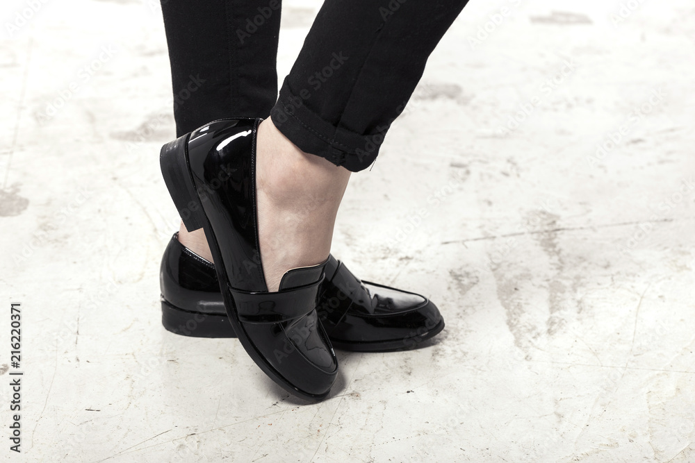 woman wearing black enamel shoes isolated white. woman wearing black enamel shoes isolated white.