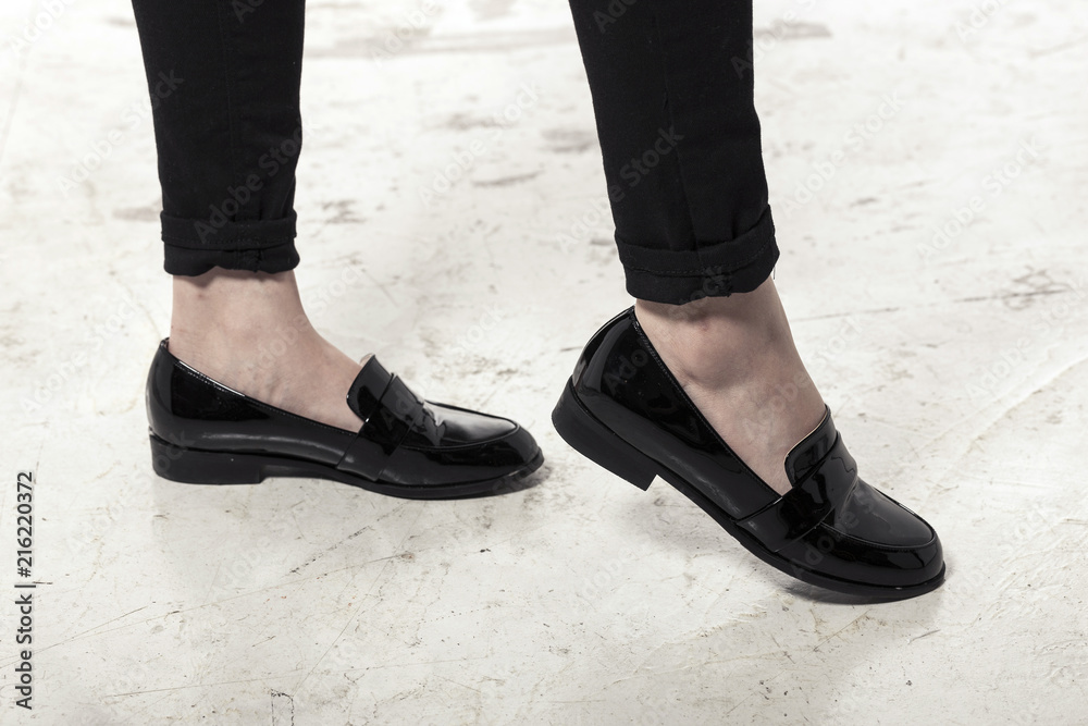 woman wearing black enamel shoes isolated white. woman wearing black enamel shoes isolated white.