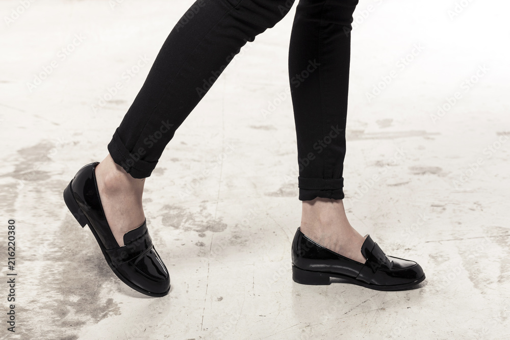 woman wearing black enamel shoes isolated white. woman wearing black enamel shoes isolated white.