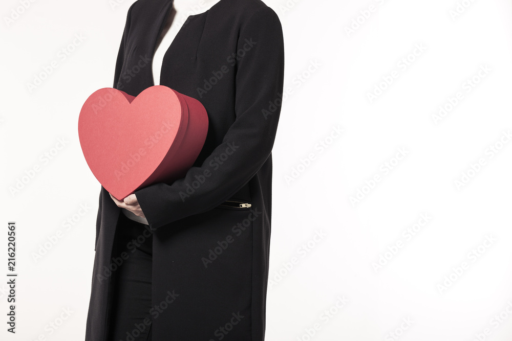 woman hand hold a red heart gift box isolated white.