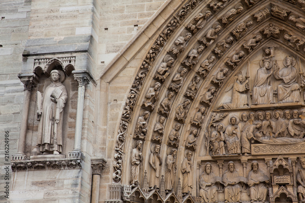 Details of the west facade of the Cathedral of Our Lady of Paris in a freezing winter day just before spring