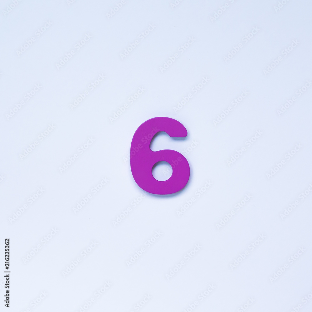 Wooden number 6 with purple color on white background. Wooden number 6 with purple color on white background.