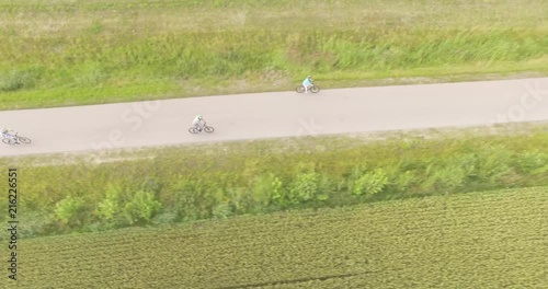 Family riding a bicyble on the road photo