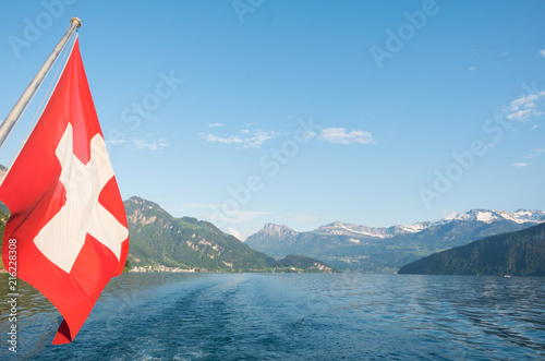 Swiss flag flying off the back of the europa lake cruise boat in lake lucerne