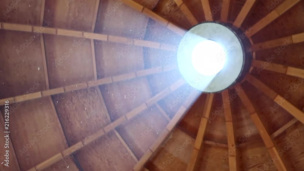 Rotating view of the light shining through the top of the Integraton structure in Landers, California. Shows the light bouncing off dust particles in the room after a sound bath.