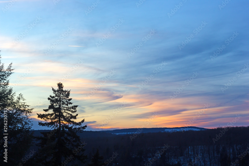 Winter sunset in Allegheny mountains. Skies at sunset with colorful clouds signature.