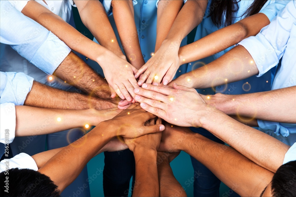 Handshake of many young business people teamwork Handshake of many young business people teamwork