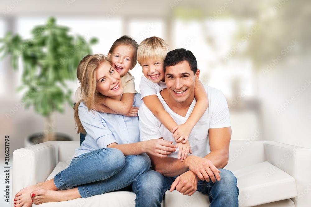 Young  family at home smiling at camera