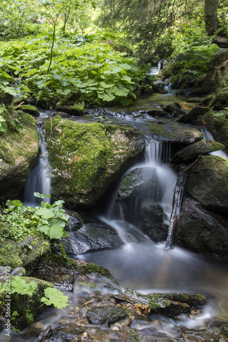 Small waterfalls on a river flowing in nature.